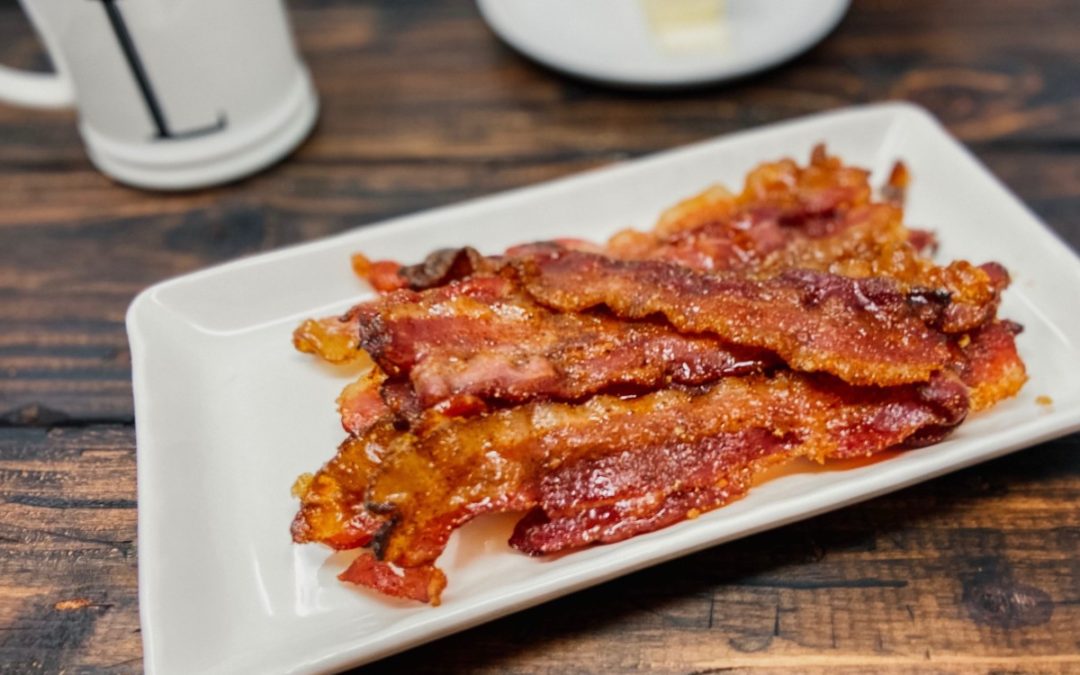 plate of bacon, bacon on a wooden table, breakfast spread with baoon